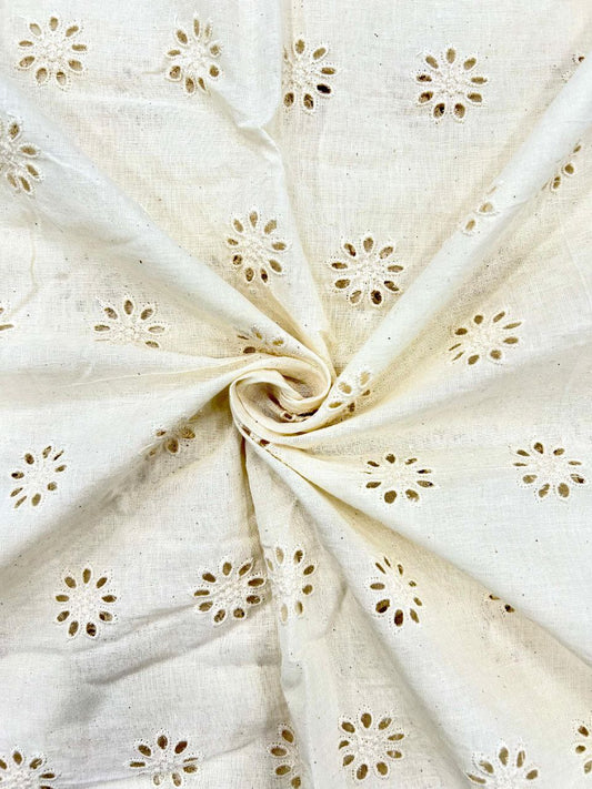 Close-up of dyeable cotton Schiffli fabric featuring a beautiful lattice-style design with flower highlights, ideal for fusion wear.