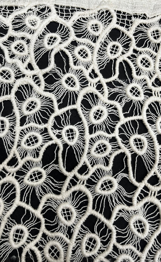 "Craft your dream outfit with this gorgeous 100% pure cotton GPO lace fabric! This dyeable white guipure textile features a stunning, intricate banded floral and netted pattern with exquisite detailing. Its super soft and breathable texture makes it the perfect summer fabric for tailoring light beach cover-ups, high-fashion overlays, breezy ethnic kurtis, or stylish Indo-Western dresses!"