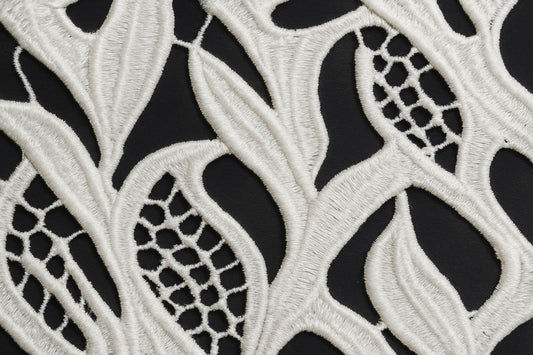 "Craft your dream outfit with this gorgeous 100% pure cotton GPO lace fabric! This dyeable white guipure textile features a stunning, intricate leaf and wave-inspired pattern with exquisite detailing. Its super soft and breathable texture makes it the perfect summer fabric for tailoring light beach cover-ups, high-fashion overlays, breezy ethnic kurtis, or stylish Indo-Western dresses!"