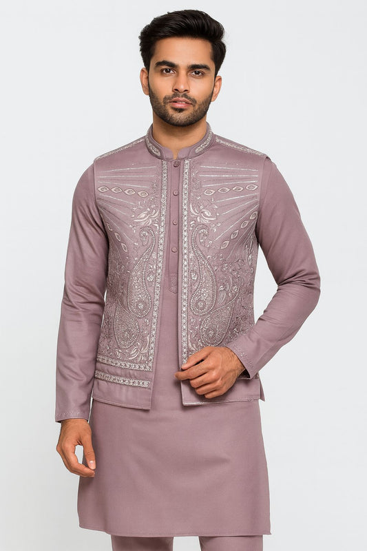"Stand out beautifully in this sophisticated lavender (or mauve) men's Kurta Koti Pajama Set! Our model showcases this premium ethnic outfit, featuring a matching embroidered koti (waistcoat) adorned with elegant silver and white paisley and floral motifs. The fine detailing and shimmering highlights blend modern style with traditional charm, making it perfect for weddings, formal parties, or festive celebrations!"