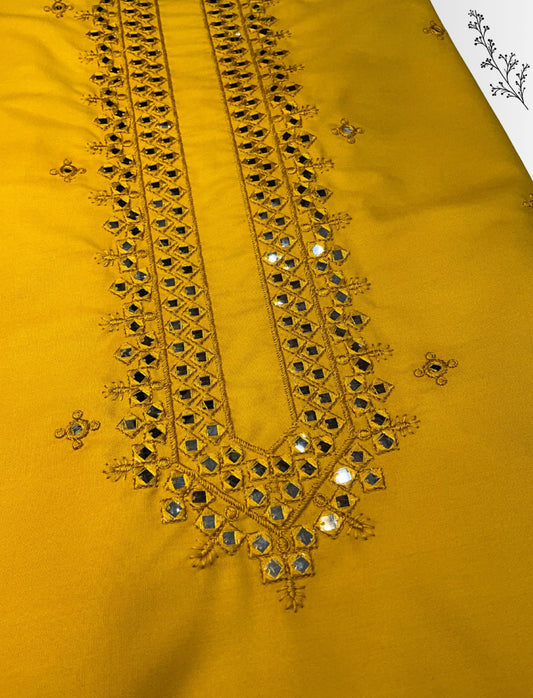 "Close-up of premium unstitched men's fabric in a vibrant mustard yellow, showcasing the heavy mirror work and detailed gold zari embroidery along the V-style neckline. This festive Indian textile is perfect for a standout kurta pajama outfit for the groom or guests at Haldi, Sangeet, or Diwali events."