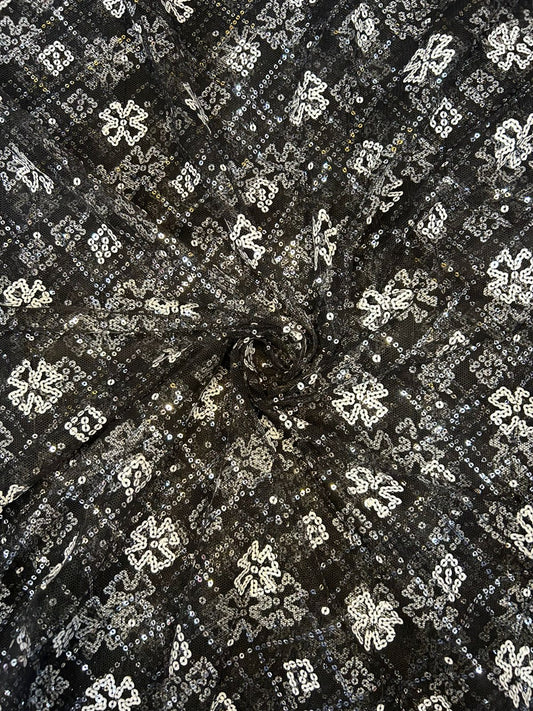 Luxury black fabric with white sequin pattern, great for creating sophisticated party wear suits and high-end apparel.
