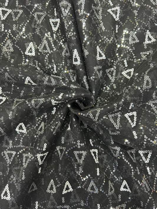 Close-up of luxury black net fabric with white sequin pattern, great for creating sophisticated festive and wedding attire.