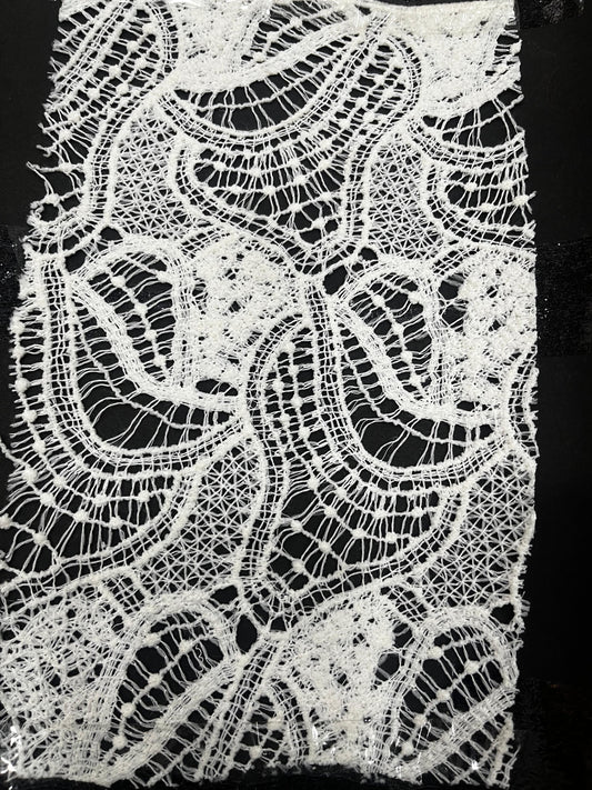 "Add a unique touch to your next project with this gorgeous 100% pure cotton GPO lace fabric! This dyeable white guipure lace features a stunning, intricate wave-inspired pattern that's perfect for light beachwear cover-ups, breathable ethnic kurtis, Indo-western dresses, or high-fashion overlays. Its soft, breathable texture is comfortable for all-day wear!"