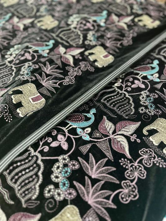 "Step into a world of beauty with this lovely premium velvet fabric! It's adorned with playful embroidered elephants, graceful peacocks, and delicate foliage, all in pretty pastels against a dark backdrop. Imagine the amazing creations you could make!"