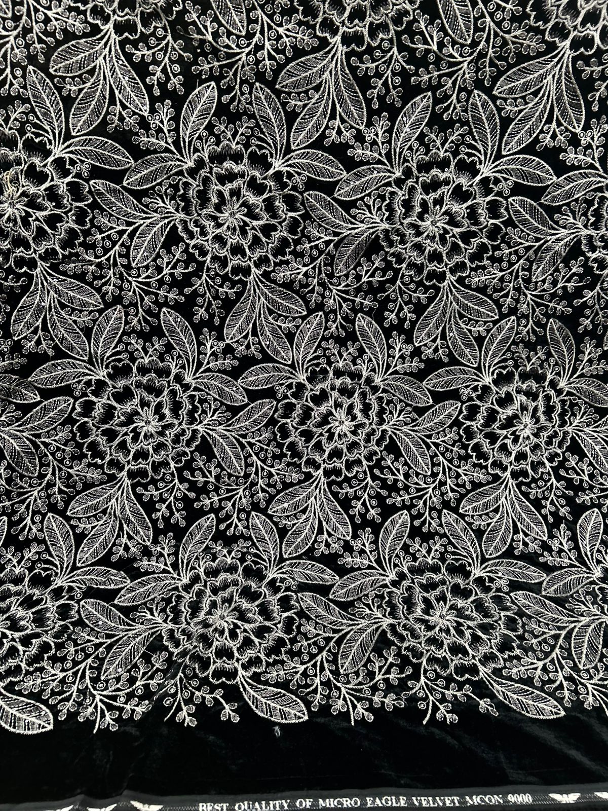  "Beautiful new black velvet fabric with dense, delightful white and silver floral embroidery. It's so plush and ready for your most glamorous creations!"