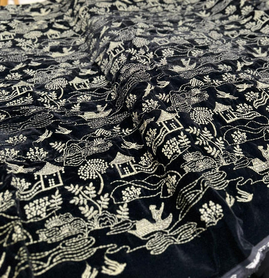Black velvet fabric with premium lime-colored embroidery – trending winter wear material.